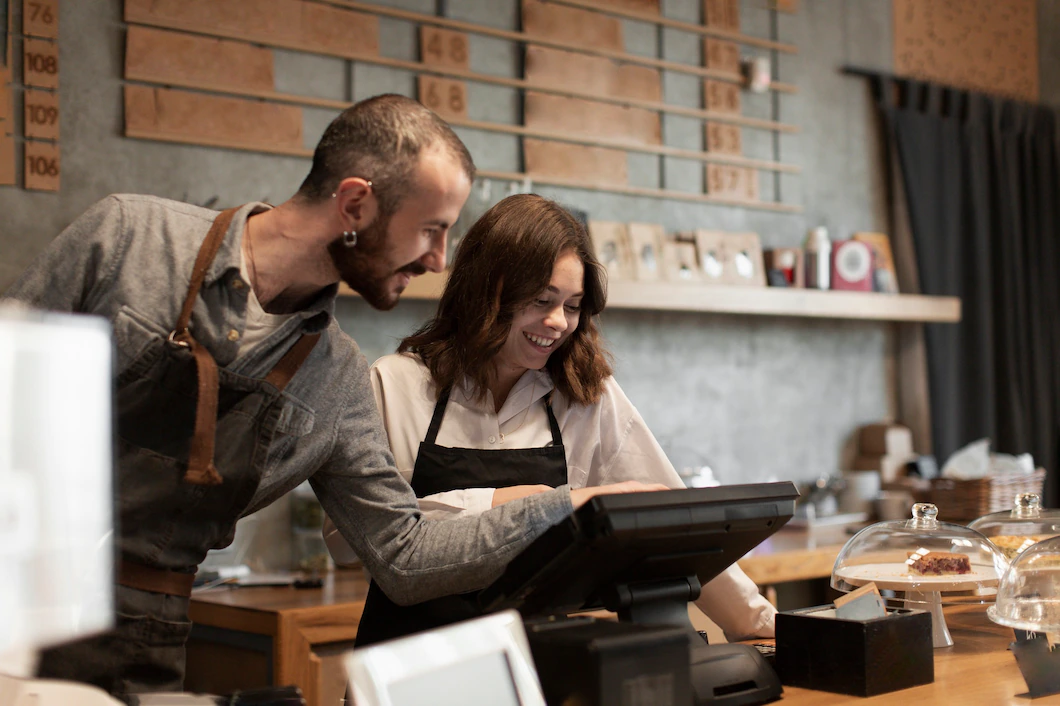 smiling man woman cash register 23 2148366645 Titantask - POS Software Retail Solutions